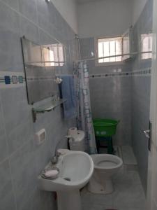 a small bathroom with a toilet and a sink at Confortable Maisonnette prés de la plage à Dar el Alouch in Kelibia