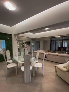 a living room with a table and chairs and a couch at Λabirinthia in Athens