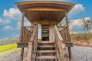 a wooden stairway leading to a tiny house at Bertha Shepherd's Hut in Lydney