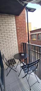 two chairs and a table on a balcony at Earl Street 122 in Sheffield