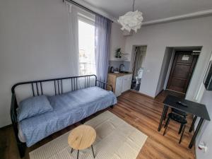a living room with a bed and a table at Cozy Apartment in Sofia Center in Sofia +8 photos