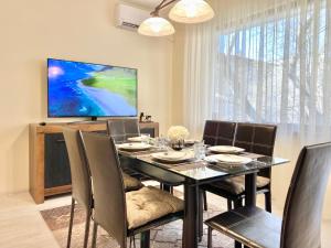 a dining room with a black table and chairs at Great 2BDR Apartment in the Centre for 6 Guests in Stara Zagora