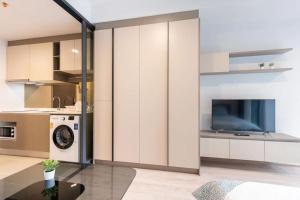 a kitchen with white cabinets and a washer and dryer at 4-mrt rame9 400m-Infinity pool/gym/shopping mall 
