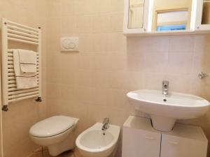 a white bathroom with a sink and a toilet at Casa Martin apt piano terra By Case al Lago in Peschiera del Garda +30 photos