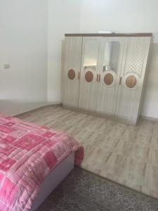 a bedroom with a bed and a dresser at Ajloun Rest House in ‘Ayn Jannā
