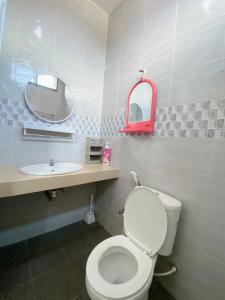 a bathroom with a white toilet and a sink at 4 bedrooms house with Private Pool ! in Kota Bharu