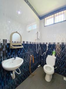 a bathroom with a sink and a toilet and a mirror at 4 bedrooms house with Private Pool ! in Kota Bharu