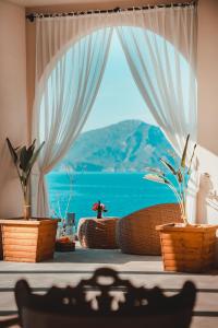 a room with a window with a view of the ocean at Zakros Hotel Lykia in Faralya