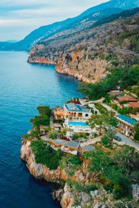 an aerial view of a resort on a rocky island in the water at Zakros Hotel Lykia in Faralya
