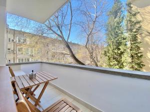 a balcony with a wooden table and a window at Great 2BDR Apartment in the Centre for 6 Guests in Stara Zagora
