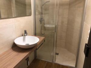 a bathroom with a sink and a shower at Apartment Grace, Mountain view in Kaprun