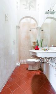 a bathroom with a toilet and a sink at VILLA MERIDA BOUTIQUE HOTEL - Adults Only in Mérida