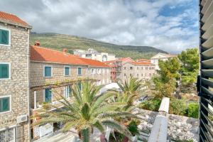 a view of a city with buildings and palm trees at Symphony Apartments Street View in Petrovac na Moru