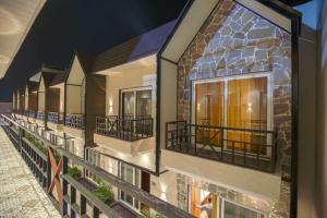 a row of balconies on a building with windows at Greenwood Villa By Levelup in Amritsar