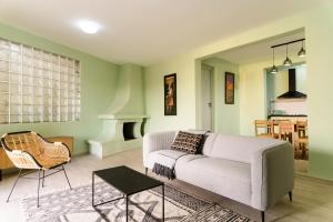 a living room with a couch and a table at Newly renovated & cozy apartment in Antananarivo