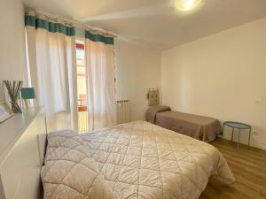 Postel nebo postele na pokoji v ubytování Vittoria Apartament