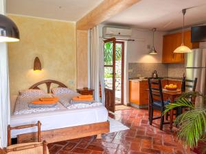 a bedroom with a bed in a room with a kitchen at Tropical Studio in Órgiva