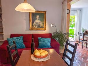 a living room with a red couch and a table with a bowl of fruit at Tropical Studio in Órgiva
