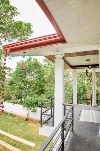 une terrasse couverte avec un auvent et une balustrade sur une maison dans l'établissement Sea Breeze Rest, à Kottagoda
