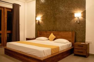 - une chambre avec un lit, deux lampes et une fenêtre dans l'établissement Lina Hotel, à Habarana