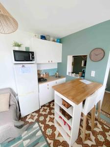 una pequeña cocina con mesa y nevera en Logement T2 ICADE ADP Orly Lenôtre J Monnet JMermoz JO 2024 en Rungis