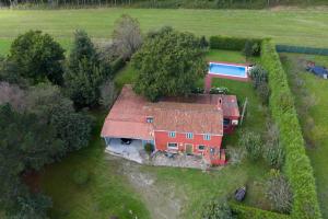 a house with a red roof and a swimming pool at Casa de Piñeiro y SPA (opcional) in Santiago de Compostela