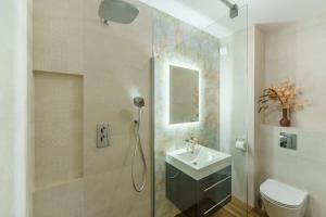 a bathroom with a shower and a sink and a toilet at CHILLIapartamenty - Wyspa Solna - RIVER in Kołobrzeg +23 photos