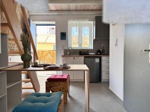a small kitchen with a table and a counter top at Surf-themed stone house at Kalliopi 2 in Kalliópi