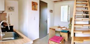 a tiny kitchen with a sink and a ladder at Surf-themed stone house at Kalliopi 2 in Kalliópi +47 photos