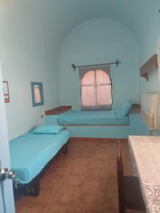 Säng eller sängar i ett rum på Nubian Holiday House Aswan