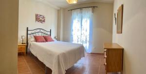 a bedroom with a large bed and a window at Apartamentos Isla Canela y Punta del Moral in Isla Canela +129 photos