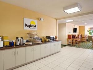 a restaurant with a counter in a room at Days Inn & Suites by Wyndham Lafayette IN in Lafayette