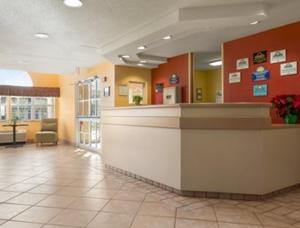 a lobby of a hospital with a reception counter at Days Inn & Suites by Wyndham Lafayette IN in Lafayette