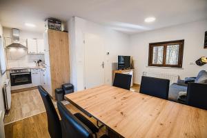 a kitchen and a dining room with a table and chairs at Holiday Home Kozorog in Bohinj