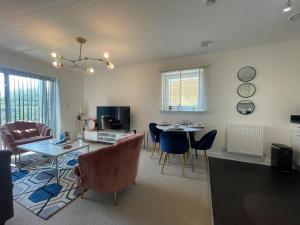 a living room with a table and chairs and a dining room at Stylish Station Apartment in Rochester with Free Parking in Wainscot