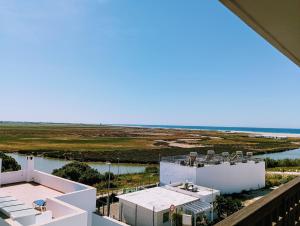 a view of the ocean from the balcony of a building at Apartamento Levante in Conil de la Frontera