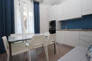 a kitchen with a table and chairs in a room at Residence Verdena appartamento 03 in Rosolina Mare +17 photos