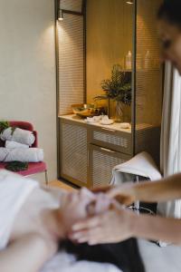 a woman laying on a bed in a room at Ego SPA in Bir&scaron;tonas