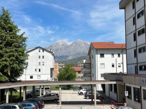 a view of a city with a mountain in the background at Il Girasole - Apartment in Avezzano