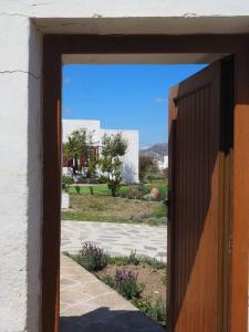 an open door with a view of a yard at Villa Depasta Cycladic house Aegean Sea view in Apollonia