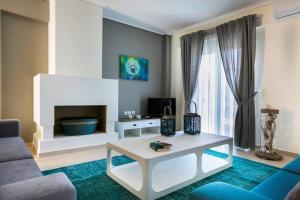 a living room with a couch and a table at Eucalyptus suite sea view in Karavomylos