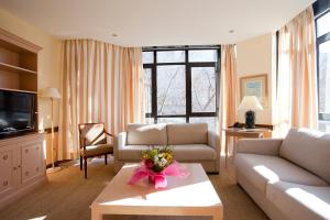 a living room with a couch and a table at Espahotel Plaza Basílica in Madrid