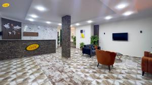 a lobby with a waiting room with chairs and a tv at Happy View Inn in Cairo