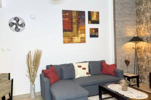 a living room with a blue couch and a table at Cowboy Charm 1BR Apartment on Yas Island in Abu Dhabi
