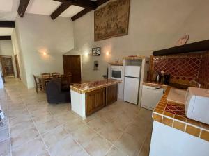 a kitchen with a refrigerator and a table at Domaine de Majastre in Bauduen