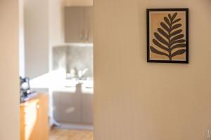a picture hanging on a wall next to a kitchen at Appartement la Toscanelle - Quartier historique - Gaillac in Gaillac +22 photos