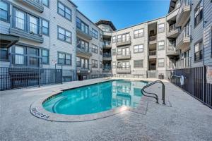 a swimming pool in front of a building at Charming and Spacious Apt in Austin with a Pool in Austin