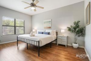 a bedroom with a bed and a ceiling fan at Charming and Spacious Apt in Austin with a Pool in Austin