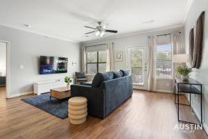 a living room with a couch and a tv at Charming and Spacious Apt in Austin with a Pool in Austin