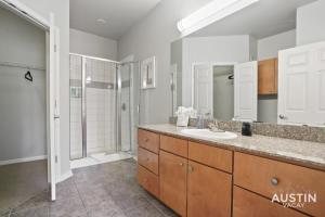 a bathroom with a sink and a shower at Charming and Spacious Apt in Austin with a Pool in Austin +14 photos